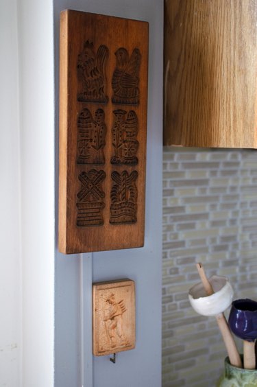 wood pieces hanging on the wall near kitchen space