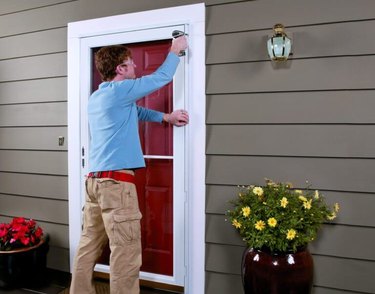 Man attaching door to trim.