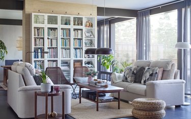 living room space with white shelves and beige couches