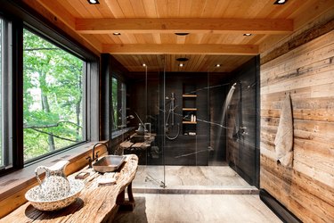 Rustic shower idea with modern accents, wood planks, and black slate walls