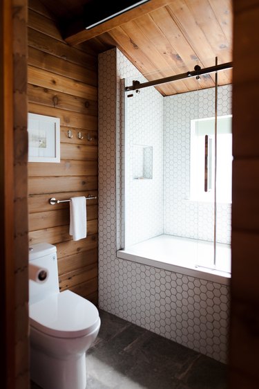 Rustic shower idea with wood planks and white honeycomb tile