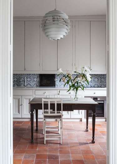 French country dining room in kitchen with Terracottas Floors by Coco Kelley