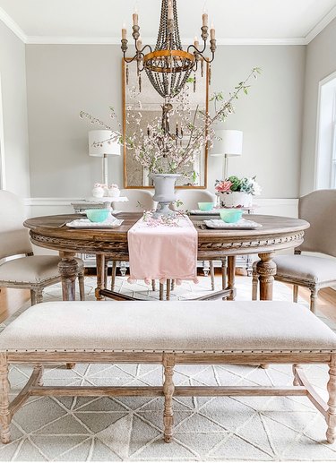 French country dining room idea with round table and chandelier