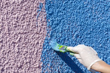 Painting stucco house.