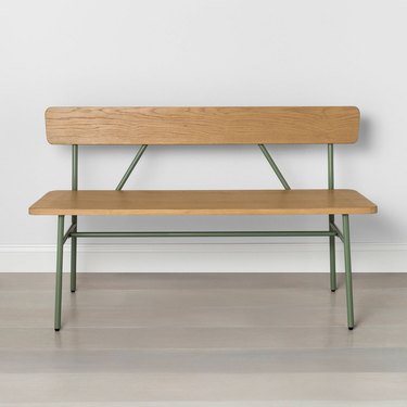 light wood bench with green metal legs