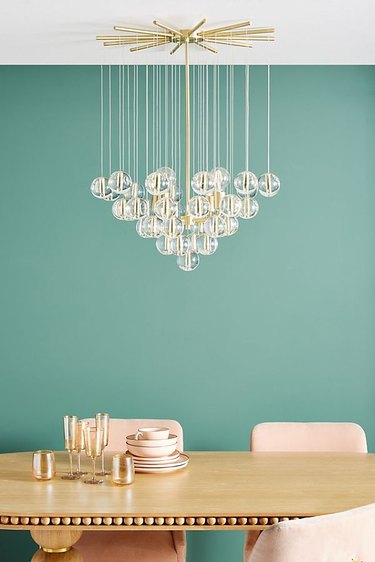 gold table with chandelier above it