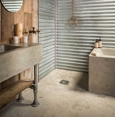 Reclaimed wood and concrete combined make this rustic bathroom utterly unique.
