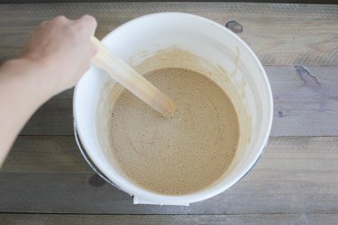 Stirring powdered lime into water