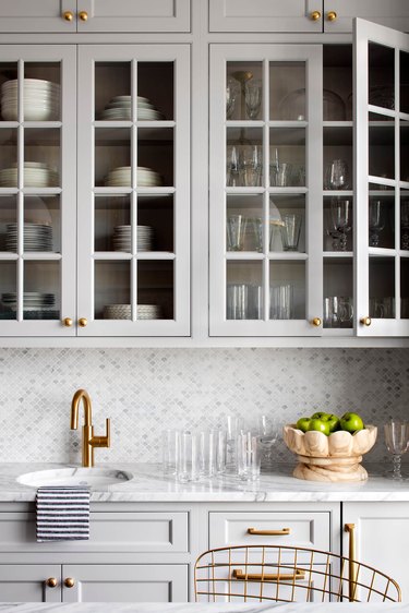 gray backsplash kitchen idea with mosaic tile and gray cabinets