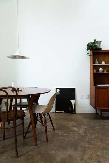 minimalist dining room table with concrete flooring