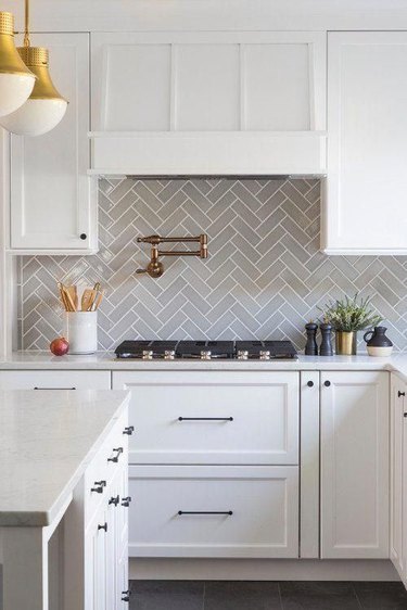 gray backsplash kitchen idea in herringbone pattern behind stove