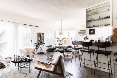 modern living room/dining room/kitchen with stained concrete floors