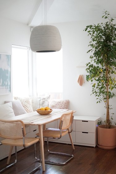 white dining room with mixed seating and cane dining chairs