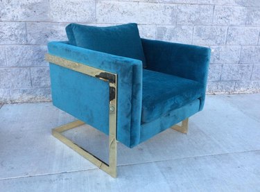 blue chair in Hollywood Regency style