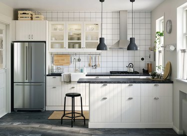 kitchen with white cabinets with boxes atop them