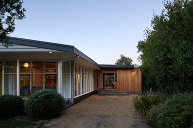 house with floor to ceiling windows near bushes