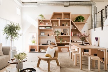 Hunker house dining room with modern bookcases and light concrete floor