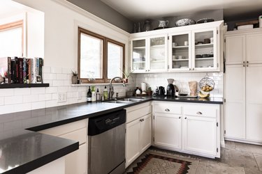 kitchen with white cabinets and kitchenware on top
