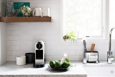 focus on white subway tile backsplash, granite countertop, wide windows