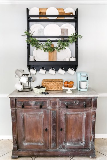 Farmhouse coffee bar with vintage cabinet and white dinnerware