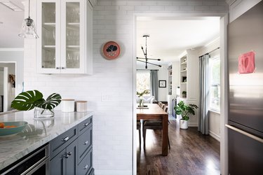 kitchen with view to dining room with hardwood floors, sunny windows, wood table