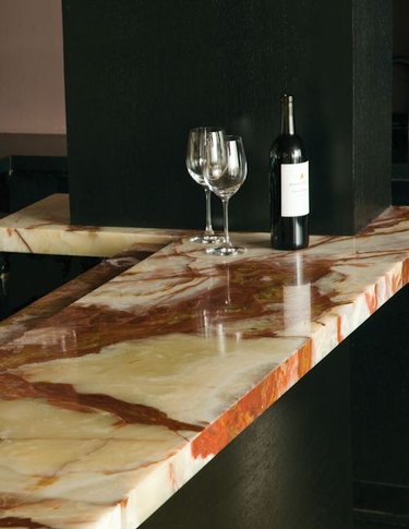 onyx countertop in kitchen with wine glasses