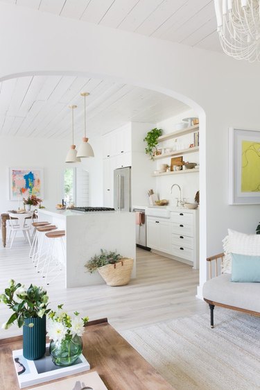 kitchen flooring with laminate flooring and white cabinets