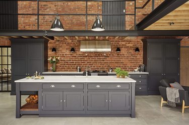 exposed brick backsplash in modern warehouse kitchen