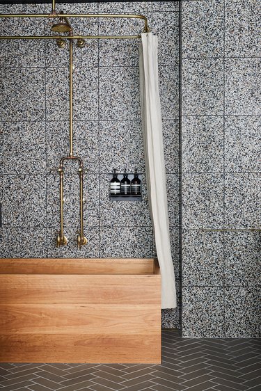 charcoal color backsplash tile bathroom with wooden tub