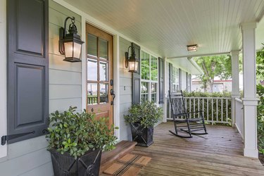 farmhouse style porch with wood floors and neutral charcoal window shutters