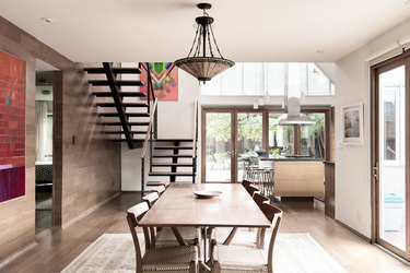 dining room space with long table and craftsman style chandelier
