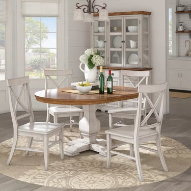 dining room space with white chairs and wood table