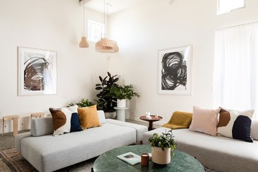 living room with rug, pendant lights, couches, concrete floors