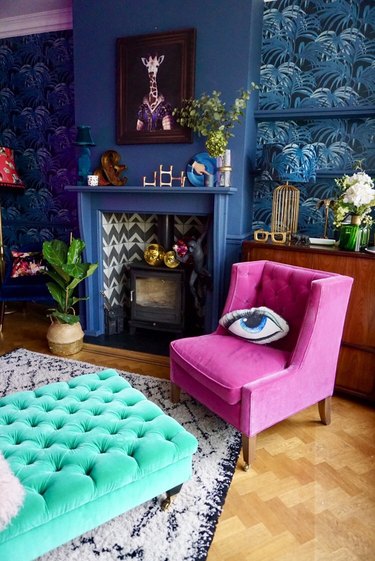 eclectic dark blue living room with botanical wallpaper