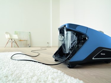 focus on vacuum and cord in white room