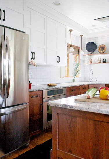 Craftsman kitchen with white upper cabinets and dark wood lower cabinets