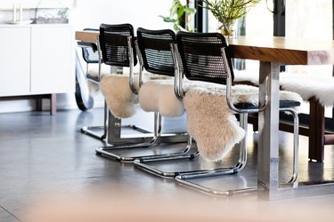 Black and steel chairs around wood dining table