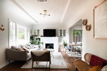 sunny living room with coved ceilings and fireplace