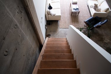 view down a wood stairway into living room