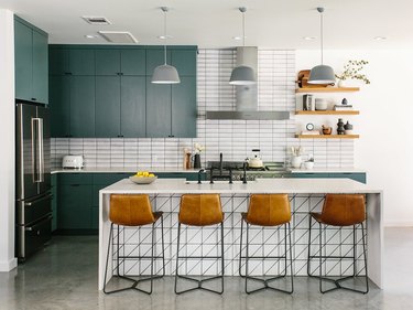 Teal kitchen idea with teal cabinets and white subway tile backsplash with midcentury decor