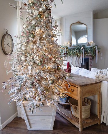 flocked farmhouse Christmas tree idea planted in wooden planter