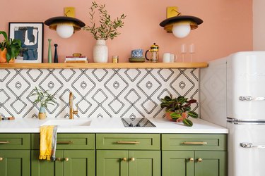 pink and olive green kitchen color idea with white countertop and patterned tile backsplash