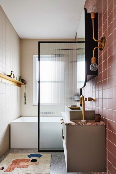 small shower idea with pink tiles and fluted glass screen