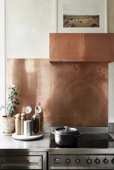 simple kitchen with copper backsplash and cooker hood