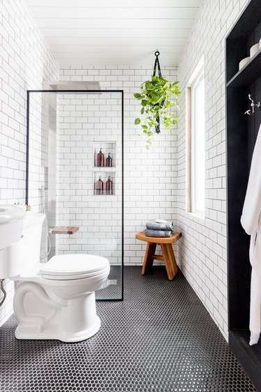 black and white bathroom with penny tile flooring