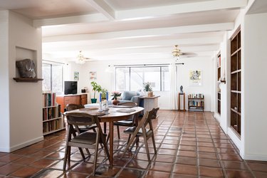 dining and living areas with clay tile floor