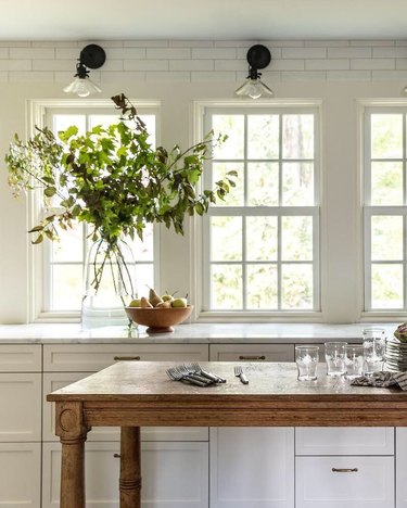 white kitchen with antique kitchen island