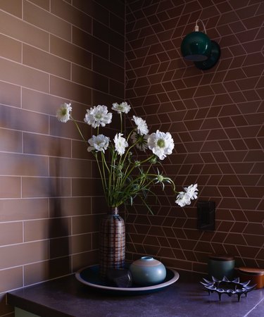 Two kinds of brown Heath tile in kitchen with Heath ceramics and flowers