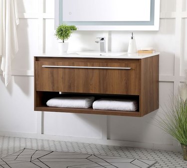 wood floating bathroom vanity in bathroom space with white wall