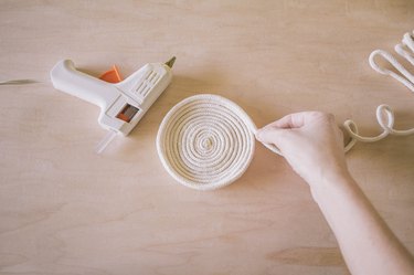 Stacking and gluing rows of rope on top of each other to create bowl